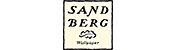 Das Logo von Sandberg Wallpaper. Es zeigt ein helles, rechteckiges Feld mit dem Namen "SANDBERG" in zwei Zeilen in schwarzer, klassischer Schrift. Unter dem Namen befindet sich ein stilisiertes Wolken- oder Baum-Symbol und darunter der kleine Schriftzug "Wallpaper".